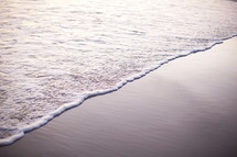 sea foam on beach sand
