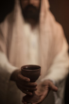 Jesus holding a communion chalice 