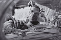 Father looking at premature baby