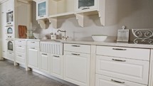 Tracking shot of a large luxury kitchen with white classic design