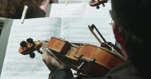 Musician playing Violin during a classical music rehearsal before a concert