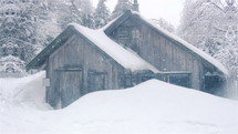 Cabin isolated in heavy snow.
