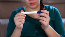 sad woman with a negative pregnancy test 