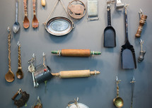kitchen tools hanging on a wall 