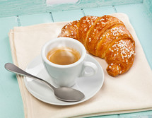 Espresso coffee with croissant in wooden tray light blue.
