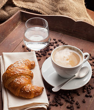 croissant, coffee, and glass of water 