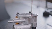 CMM measuring machine probing a high precision metal part