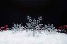 snowflake Christmas ornaments in snow 