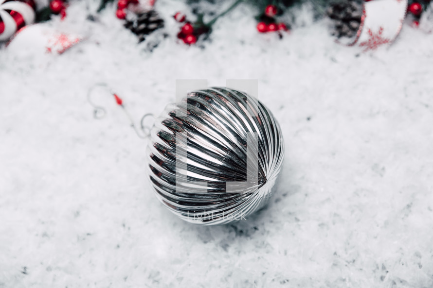 silver ornament in snow 