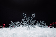 snowflake Christmas ornaments in snow