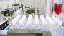 Automated pharmaceutical manufacturing line, bottles filled with liquid
