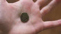 a coin in a hand 
