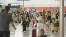 Paris, France - June 25, 2023. Passengers walking inside terminal 2 at Charles de Gaulle airport