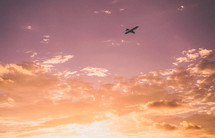 small plane in the sky at sunset 