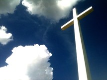 the reach of the cross that reaches from heaven to earth against a blue sky and clouds. What an amazing view and reminder of Gods love that He came down from Heaven to Earth to minister to each of us and win us back one at a time to a restored relationship with Christ and God the Father. 
