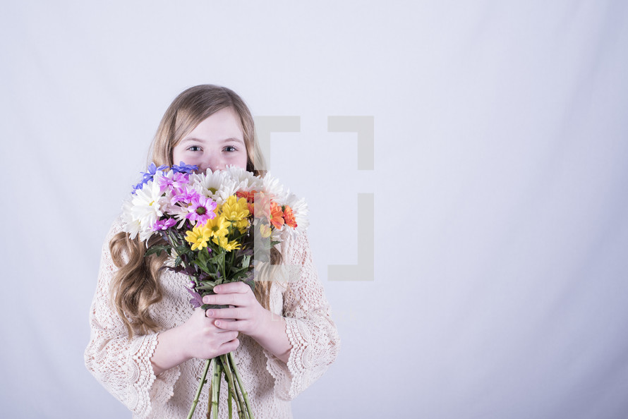 a girl holding a bouquet of flowers 
