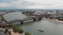 Aerial slow left pan of the Rhine River and cityscape of Cologne, Germany.