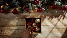 Hands Opening a Box full of Christmas balls 