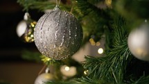 Silver ball on the branches of a christmas tree 