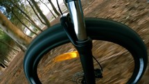 Front wheel of mountain bike on forest terrain