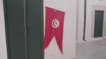 Tunisian Flag on White Wall in Sidi Bou Said, Tunisia