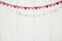 hearts and arrows banners on a white wall 