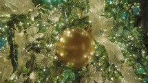Beautiful Illuminated Christmas Tree Decoration. Colorful Blue Round Balls, Golden Ribbons, Starfish and Sea Shell Ornaments. Close Up.	
