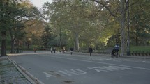 Manhattan, New York City, USA - October Central Park Fall Foliage - People Walking, Biking and Jogging in the Morning