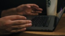Hands of a man on a laptop keyboard 