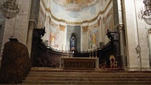 Altar with frescoes and columns inside a christian church