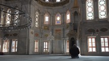 Muslim Man Salah salat Pray inside Nuruosmaniye Camii Mosque Architecturally significant Ottoman mosque Istanbul, Turkey