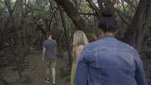 people walking through the woods 