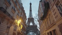 The majestic Eiffel Tower as seen from the residential area of Rue de l'Université, Paris.