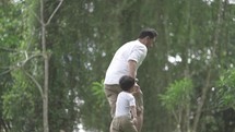Portrait of Asian Father and Child Love Enjoying Activities at The Park - Playing, Holding Hand, Running in Slow Motion