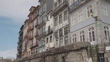 Porto, Portugal - A narrow street alleyways by the Douro River, Porto's old town with historic buildings and restaurants, the promenade and Ponte Luís I bridge.