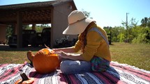 Woman cutting pumpkin 