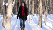 woman walking on a snowy path 