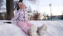 Child girl play in winter park Outdoor. Teen girl walks outdoors in cold winter. Carefree childhood. Portrait of charming girl outdoors.