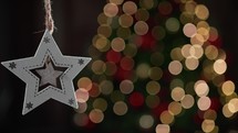 Christmas Star decoration with blurred tree 