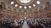 Paris, France - March 19, 2024: The Salle Ovale at the Bibliothèque Nationale de France, Richelieu an elegant oval room wood-paneled walls and beautiful ceiling, adorned with valuable book collection