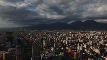 Drone view capital of Albania, Tirana city view with mountains and clouds in the background