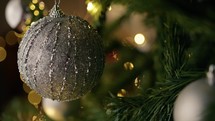 Silver balls and lights decorating a christmas tree