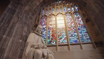 The interior of Manchester Cathedral filled with Gothic-themed ornaments such as stained glass windows and statues.