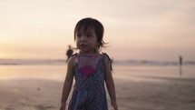Happy Indonesian Toddler Walking, Dancing, Laughing, Enjoying Sunset at The Beach