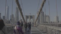 people crossing the Brooklyn Bridge 