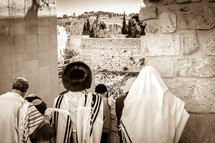 Orthodox Jews looking down at People praying at the Wailing Wall during a holiday.