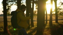Travel Concept. Silhouette hiker man travelling alone with backpack. Traveling alone thinking about life. A man is walking along against the sunset.