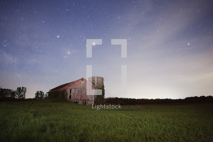 barn under stars in the night sky 
