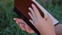 a woman closing a Bible 