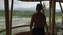 Man Healing Yoga Meditation Facing Mountain and Green Rice Field Slow Motion